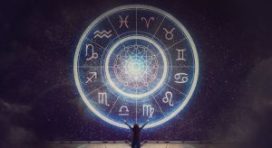 Person gazing at glowing zodiac wheel in the night sky symbolizing best astrologer near me