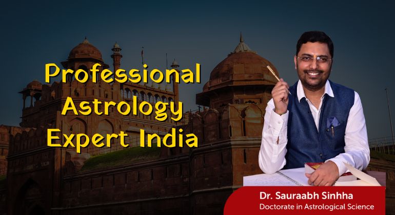 Dr. Sauraabh Sinhha holding a pen and smiling, seated with open books in front of the Red Fort, with the text "Professional Astrology Expert India" in bold yellow letters and a label reading "Doctorate in Astrological Science".